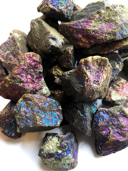 Raw, natural Chalcopyrite Peacock Ore pieces, shimmering with metallic luster, reflecting their crown chakra opening and meditative properties.