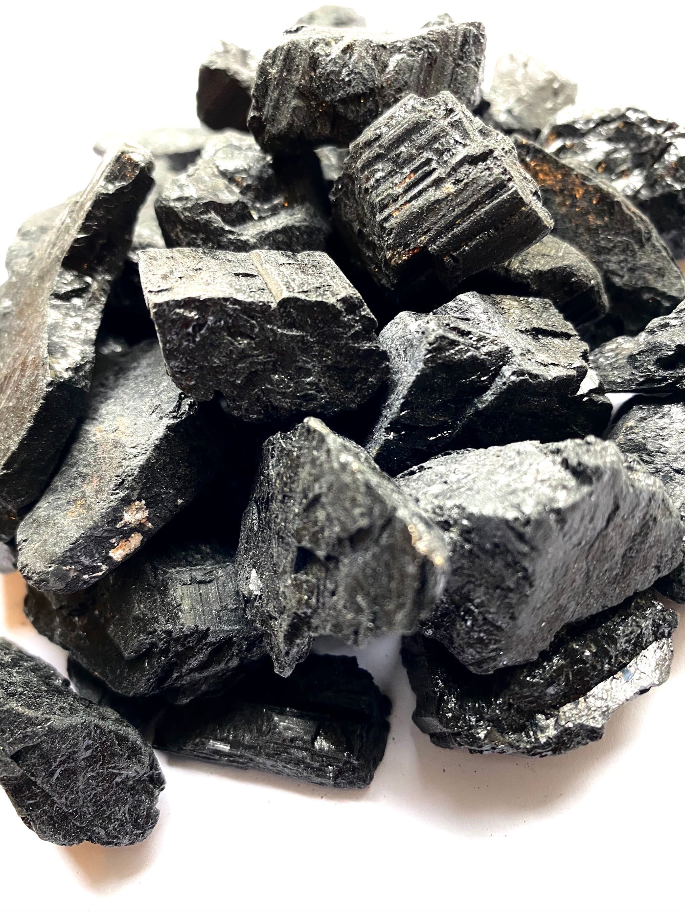 Rugged black tourmaline crystals, known for their protective energy, offering a sense of grounding and stability to any space.